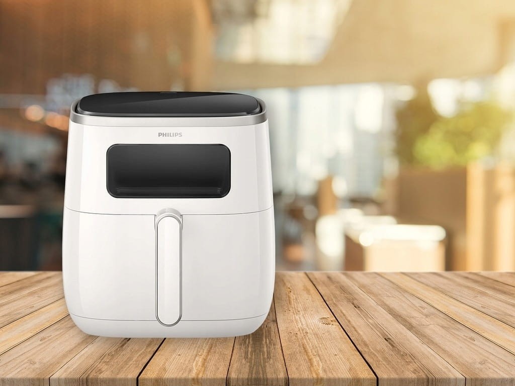 Philips Ovi Airfryer z okienkiem na drewnianym stole w jasnej kuchni HD9257/00